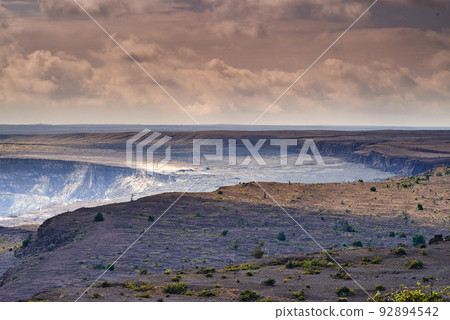 Landscape of cooled lava flow on Big Island of Hawaii. Scenic view of Mauna Kea, a dormant volcano in a remote area with copy space. Vast expanse of nature and cloudy sky near summit of volcanic land Landscape of cooled lava flow on Big Island of Hawaii. Scenic view of Mauna Kea, a dormant volcano in a remote area with copy space. Vast expanse of nature and cloudy sky near summit of volcanic land 92894542