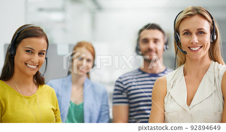 We're invincible. A group of colleagues standing with headsets at the office. We're invincible. A group of colleagues standing with headsets at the office. 92894649