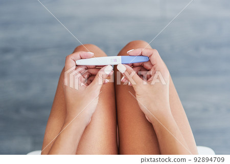 Is it the result you wanted. Cropped shot of an unrecognizable woman taking a pregnancy test at home. Is it the result you wanted. Cropped shot of an unrecognizable woman taking a pregnancy test at home. 92894709