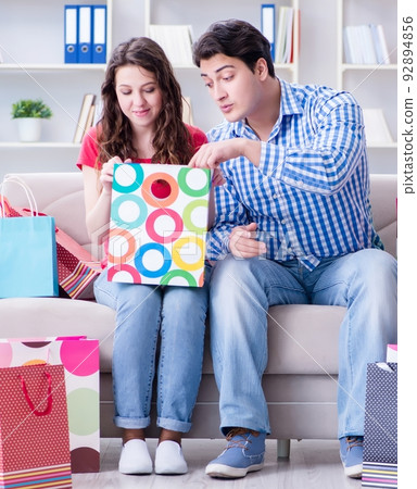 The young pair after shopping with many bags The young pair after shopping with many bags 92894856