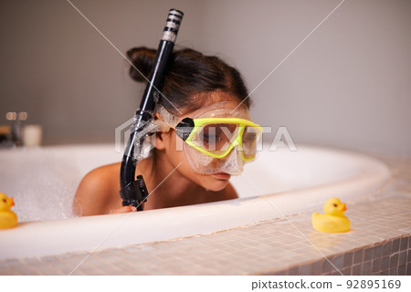Like a duck to water. Shot of a cute little girl wearing snorkeling gear in the bath. Like a duck to water. Shot of a cute little girl wearing snorkeling gear in the bath. 92895169