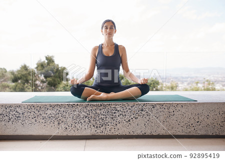 Calling upon peace. Shot of a young woman in the lotus position. 92895419