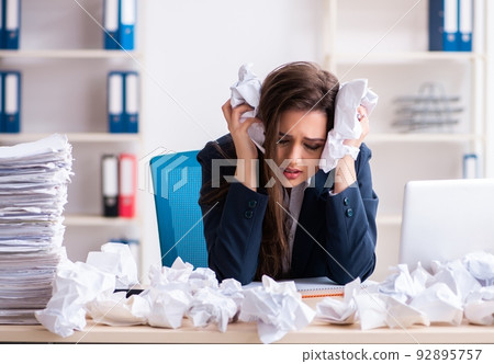 Businesswoman rejecting new ideas with lots of papers 92895757
