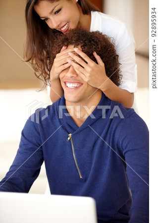 Guess who. Beautiful woman surprising her boyfriend at home. Guess who. Beautiful woman surprising her boyfriend at home. 92895934