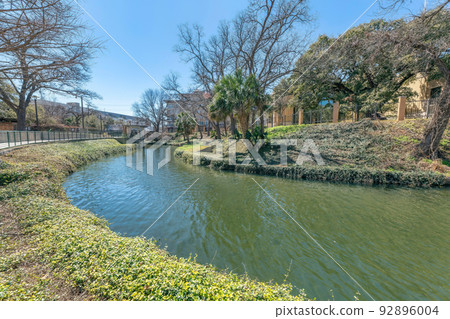 Small river with curved path near the neighborhood in San Antonio, Texas 92896004
