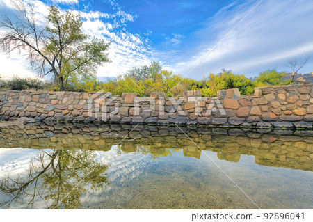 Creek with reflective water near the stone bridge at Sabino Canyon State Park in Tucson, Arizona Creek with reflective water near the stone bridge at Sabino Canyon State Park in Tucson, Arizona 92896041