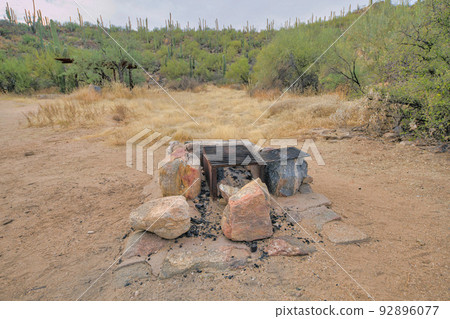 Natural rock fire pit with box grills in the middle at Tucson, Arizona Natural rock fire pit with box grills in the middle at Tucson, Arizona 92896077