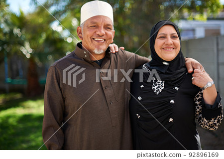 Living life with love. Portrait of a smiling senior muslim couple outside. 92896169