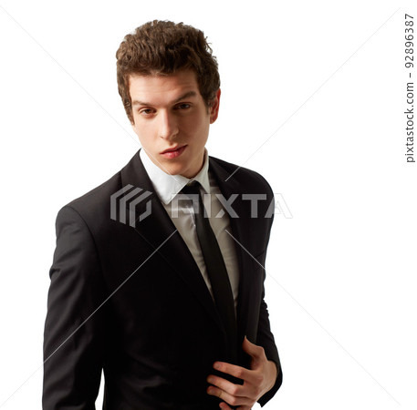 Eat your heart out James Bond. A suave young man wearing a suit looking at the camera. Eat your heart out James Bond. A suave young man wearing a suit looking at the camera. 92896387
