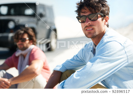 Roadtrip vibes. Shot of a young man on a roadtrip. Roadtrip vibes. Shot of a young man on a roadtrip. 92896517