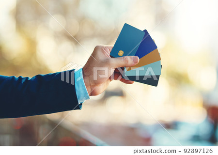 Theres one to suit your individual needs. Closeup shot of an unidentifiable businessman holding a selection of credit cards. Theres one to suit your individual needs. Closeup shot of an unidentifiable businessman holding a selection of credit cards. 92897126