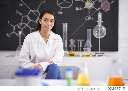 All the tools she needs to succeed. Portrait of a female scientist sitting in a laboratory. All the tools she needs to succeed. Portrait of a female scientist sitting in a laboratory. 92897745