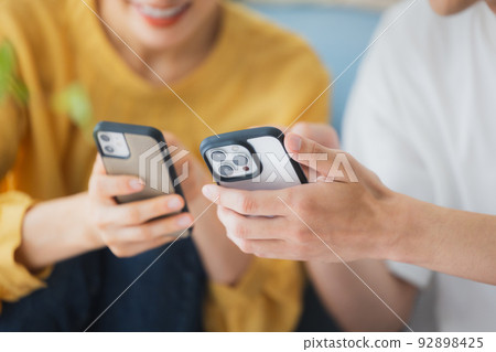 A couple in the living room A couple in the living room 92898425