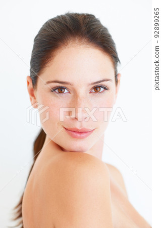 She is full of confidence. A young confident woman looking at the camera isolated on white. 92899265