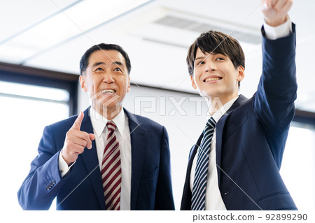 Two male businessmen (senior, young, suit, tie Two male businessmen (senior, young, suit, tie 92899290