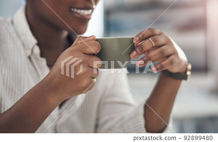 Coffee is my relaxing remedy. Shot of a businesswoman enjoying a cup of coffee at work. Coffee is my relaxing remedy. Shot of a businesswoman enjoying a cup of coffee at work. 92899480