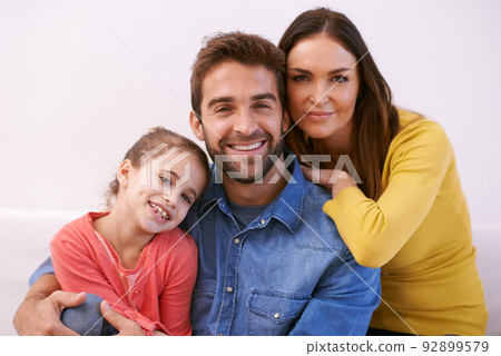 Family is what happens when two people fall inlove. Portrait of a happy young family sitting together at home. 92899579