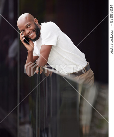 ive been looking forward to your call. Shot of a young businessman taking a break to use his smartphone to make a call. ive been looking forward to your call. Shot of a young businessman taking a break to use his smartphone to make a call. 92899834