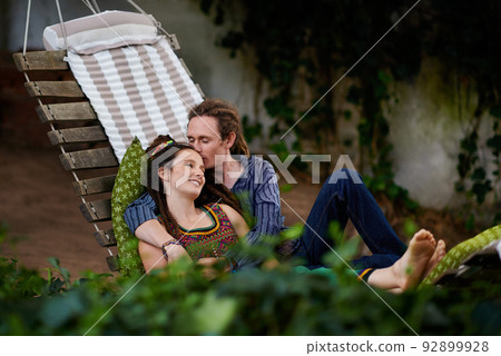 Relaxing with my favourite person. Cropped shot of a young hippie couple outdoors. Relaxing with my favourite person. Cropped shot of a young hippie couple outdoors. 92899928