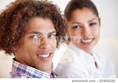 Quality together. Shot of a young ethnic couple smiling while sitting together in their home. Quality together. Shot of a young ethnic couple smiling while sitting together in their home. 92900206