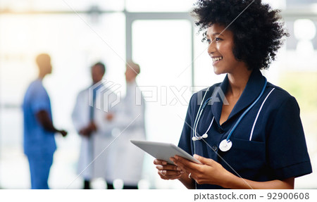Nurse, medical professional and healthcare worker with tablet and afro feeling happy after checking positive test result reports on technology. Smiling and friendly doctor ready to help in hospital Nurse, medical professional and healthcare worker with tablet and afro feeling happy after checking positive test result reports on technology. Smiling and friendly doctor ready to help in hospital 92900608