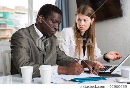 Man and woman managers with laptop working and drink coffee Man and woman managers with laptop working and drink coffee 92900669