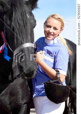 Hes more than just an animal to me. Shot of a beautiful young woman standing next to her horse. Hes more than just an animal to me. Shot of a beautiful young woman standing next to her horse. 92900887