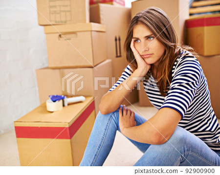 Will these boxes ever end. Shot of an attractive young woman busy moving house. 92900900