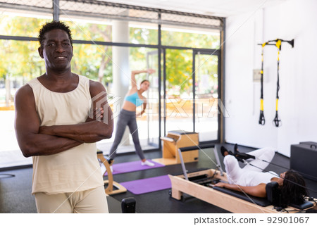 Portrait of man in sportswear posing in pilates studio. Healthy lifestyle and fitness concept Portrait of man in sportswear posing in pilates studio. Healthy lifestyle and fitness concept 92901067