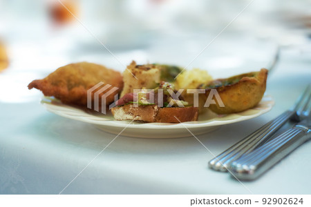 Closeup of savoury snacks served on porcelain plate and dish at a high tea event or fine dining restaurant. Texture detail of tasty pastry, pies and antipasto bread with meat for eating and tasting Closeup of savoury snacks served on porcelain plate and dish at a high tea event or fine dining restaurant. Texture detail of tasty pastry, pies and antipasto bread with meat for eating and tasting 92902624