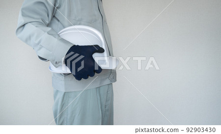 A man in work clothes with a helmet. Construction industry image. 92903430