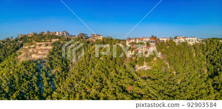 Austin, Texas- Panorama of a rich neighborhood on top of a rocky slope of a mountain with trees 92903584