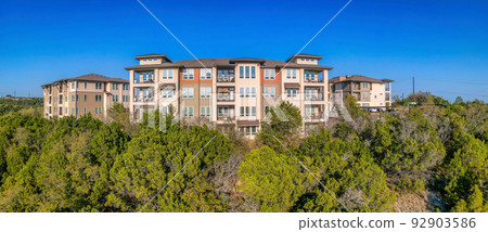 Austin, Texas- Facade of apartment building with balconies and picture windows in a panoramic view 92903586
