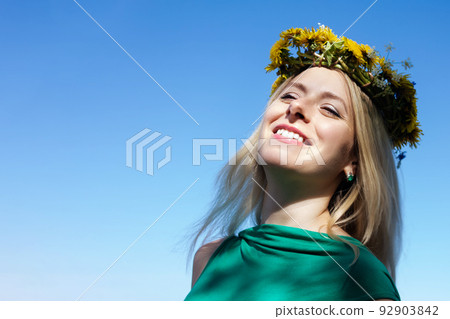 Young woman with flowers wreath on head. 92903842