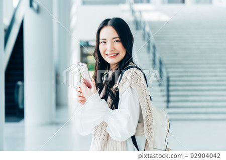 College girl looking at a smartphone 92904042
