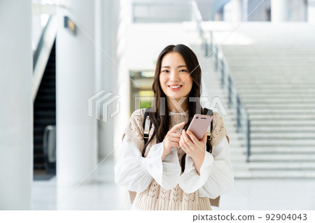 College girl looking at a smartphone 92904043