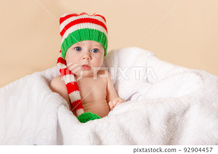Happy baby celebrates Xmas. Beautiful little child celebrates New Year 92904457