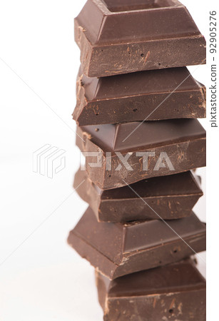 chocolate pieces. dark chocolate bars stacked high chocolate pieces. dark chocolate bars stacked high 92905276