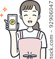 Illustration material of a housewife who works with a smartphone 92906047