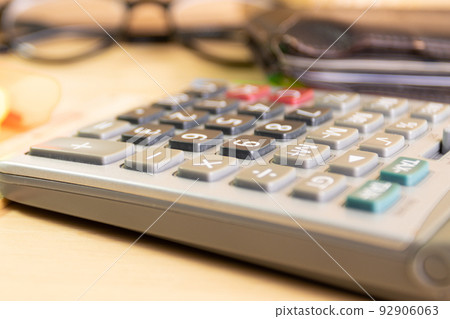 close up calculator equipment for income, expenditure, calculation on wood table close up calculator equipment for income, expenditure, calculation on wood table 92906063