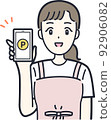 Illustration material of a housewife who works with a smartphone 92906082