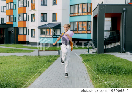 A happy student runs to school, hurries to classes, rejoices in the new academic year. Back to school A happy student runs to school, hurries to classes, rejoices in the new academic year. Back to school 92906843