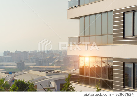 Modern high-rise residential building with glass panoramic windows. 92907624