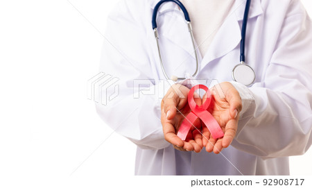 Woman medical doctors in uniform holding support HIV AIDS awareness red ribbon Woman medical doctors in uniform holding support HIV AIDS awareness red ribbon 92908717