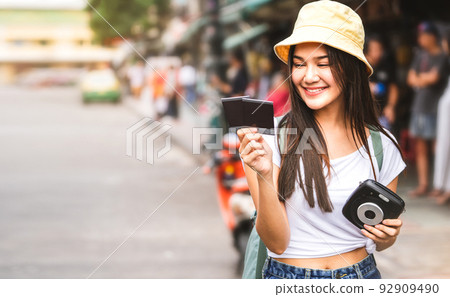 Asian Traveler woman with instant camera at Khaosan 92909490
