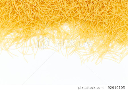 Uncooked vermicelli pasta on white background. Raw dry filini vermicelles. 92910105