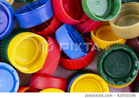 Plastic bottle caps background. Cap material is recyclable. 92910106