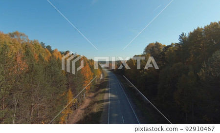 FPV drone high-speed flight along the road and autumn forest in Ural FPV drone high-speed flight along the road and autumn forest in Ural 92910467