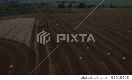 Farm worker on agriculture fields in Altai under thunderstorm sky Farm worker on agriculture fields in Altai under thunderstorm sky 92910468