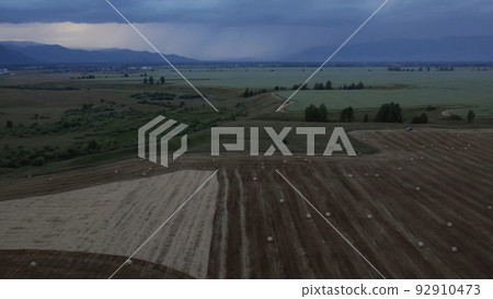 Agriculture brown fields in Altai under thunderstorm sky Agriculture brown fields in Altai under thunderstorm sky 92910473